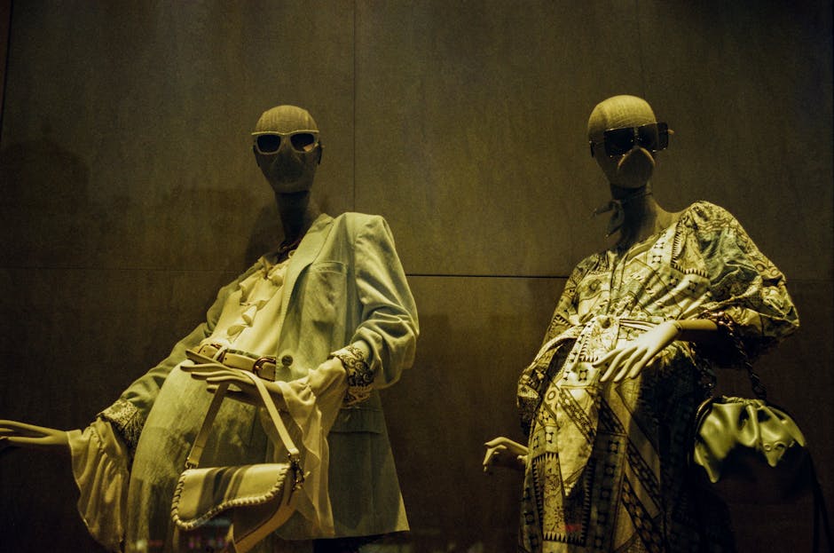 Chic window display featuring mannequins in stylish outfits, offering a sense of luxury fashion.